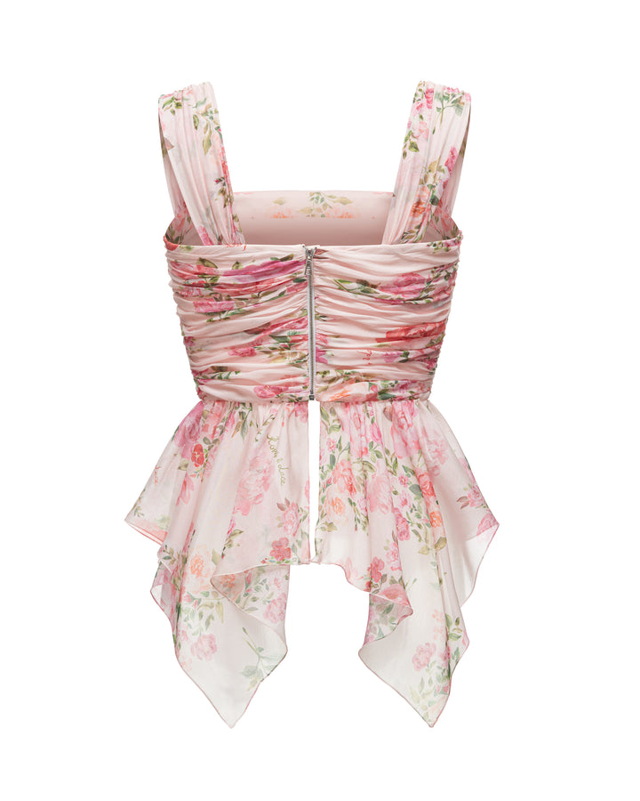 JEAN, A BABY PINK CORSET TOP WITH AN ASYMMETRICAL PEPLUM, ADORNED WITH MEDIUM-SIZED PINK FLOWERS