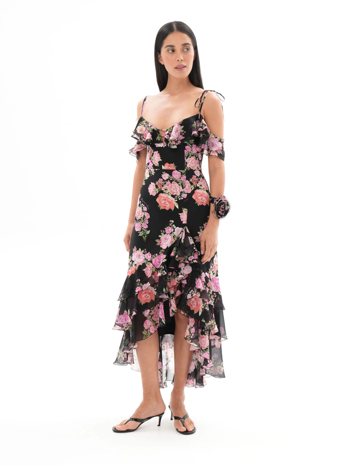 MONICA, A BLACK MAXI DRESS WITH SHORT SLEEVES AND RUFFLES, ADORNED WITH MEDIUM-SIZED PINK FLOWERS