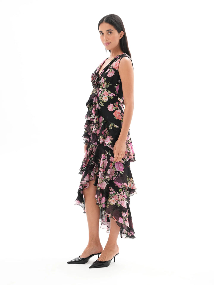 BEATA, A BLACK MIDI DRESS ADORNED WITH MEDIUM-SIZED PINK FLOWERS