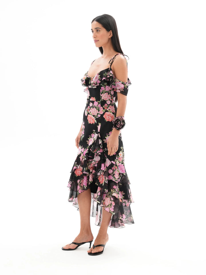 MONICA, A BLACK MAXI DRESS WITH SHORT SLEEVES AND RUFFLES, ADORNED WITH MEDIUM-SIZED PINK FLOWERS