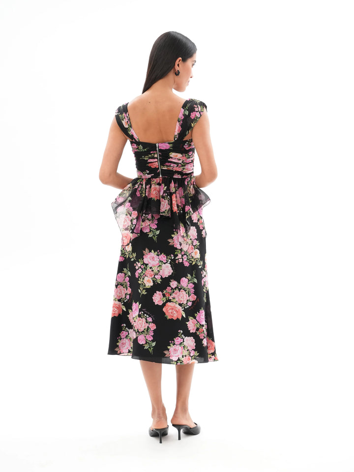 JEAN, A BLACK CORSET TOP WITH AN ASYMMETRICAL PEPLUM, ADORNED WITH MEDIUM-SIZED PINK FLOWERS