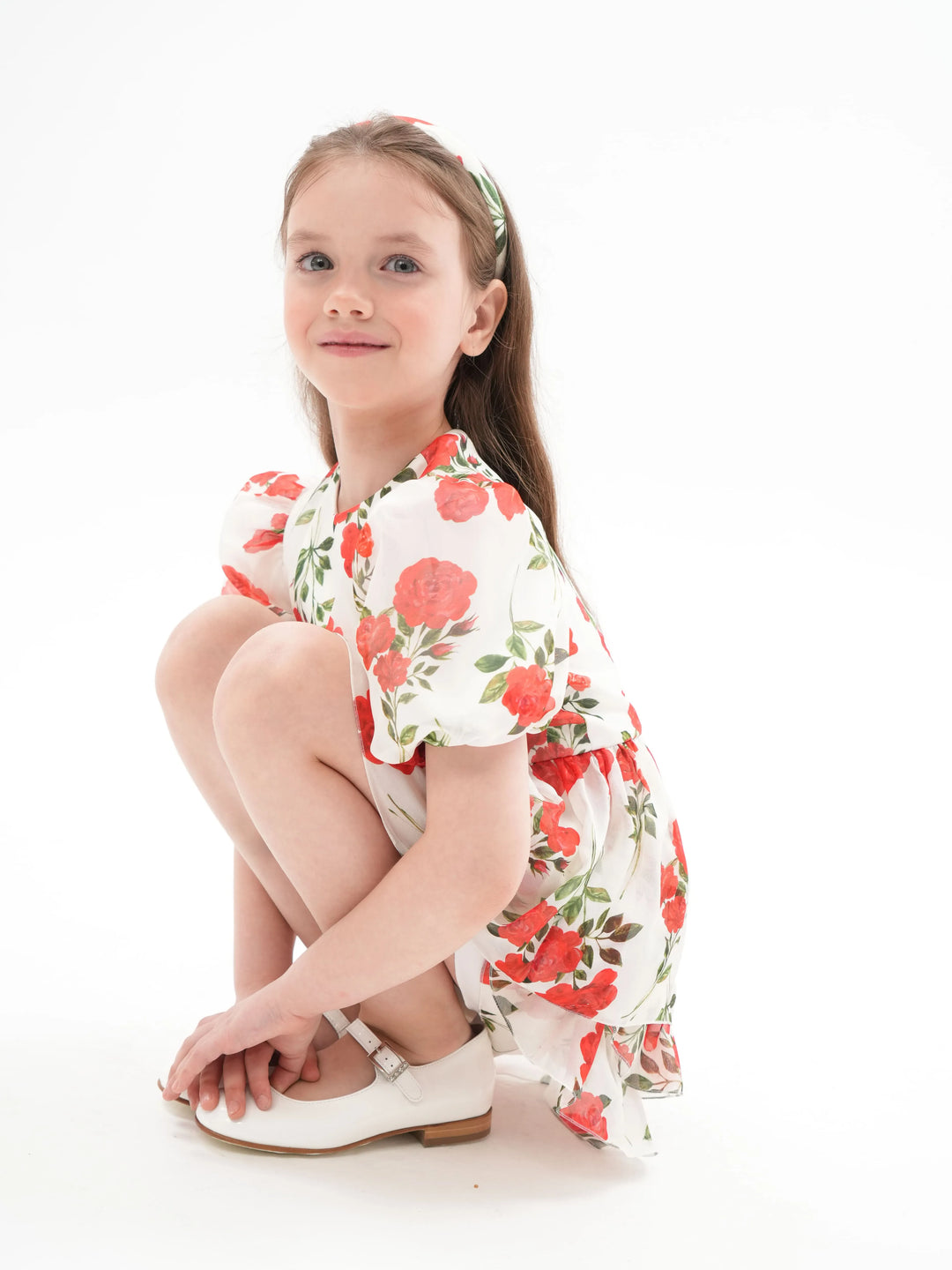 FIFI, A CHILDREN'S DRESS IN CREAMY WHITE WITH MEDIUM-SIZED RED FLOWERS